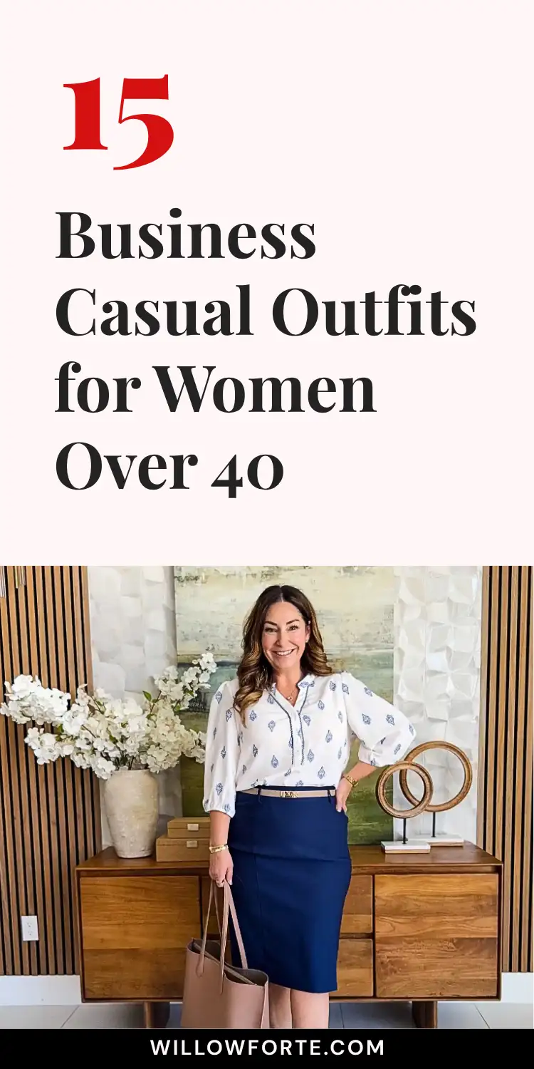 15 Business Casual Outfits for Women Over 40 17 A smiling woman with wavy brown hair stands by a wood credenza with white flowers and wooden ring decor, wearing a white tie neck blouse with a small medallion print tucked into a navy pencil skirt outfit with a gold belt detail, holding a taupe tote bag for work. Bold black text above reads 15 Business Casual Outfits for Women Over 40, spotlighting this women's professional attire look.