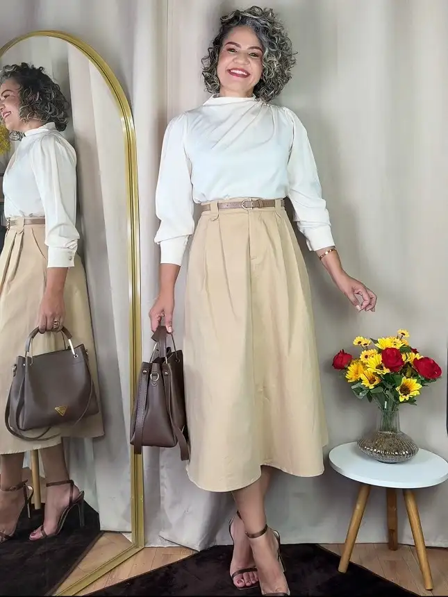 An Ivory Draped Blouse With a Belted Khaki Midi Skirt