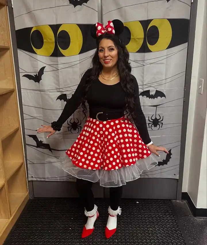 A Grown Up Minnie Mouse With a Red Polka Dot Skirt