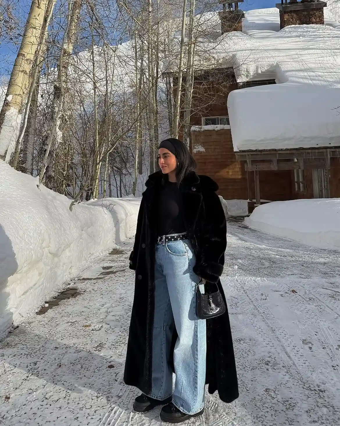 19 Winter Vacation Outfits Over 40 (Warm Getaways) 20 19. Long Black Plush Coat With Wide Leg Jeans