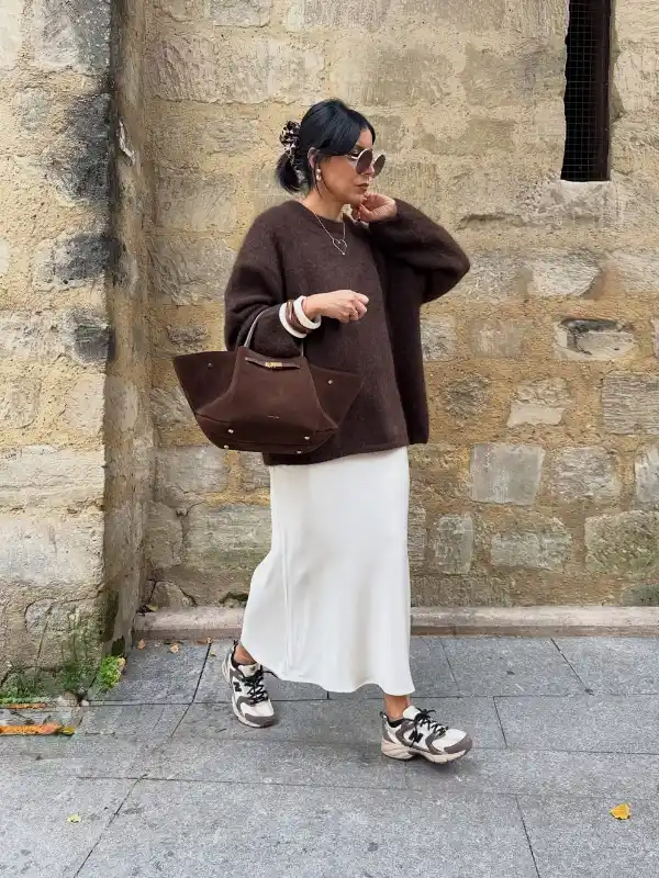 15 Fall Transitional Outfits for Women Over 40 (Summer-to-Fall) 10 9. Slouchy Brown Knit Over an Ivory Satin Slip Skirt