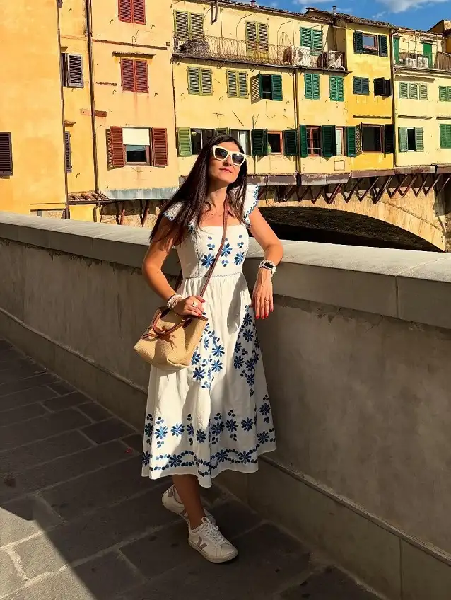 15 European Vacation Outfits for Women Over 40 11 White Embroidered Midi Dress with Sneakers in Florence