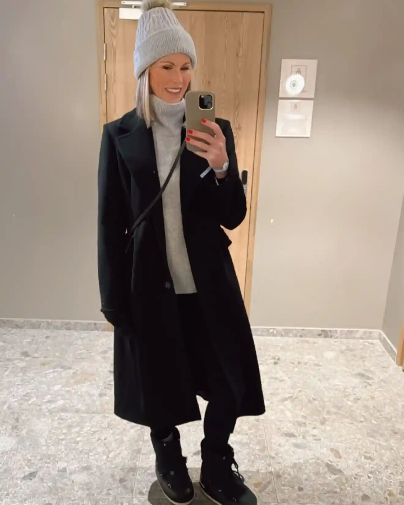 7. Long Black Coat With a Gray Turtleneck and Black Snow Boots