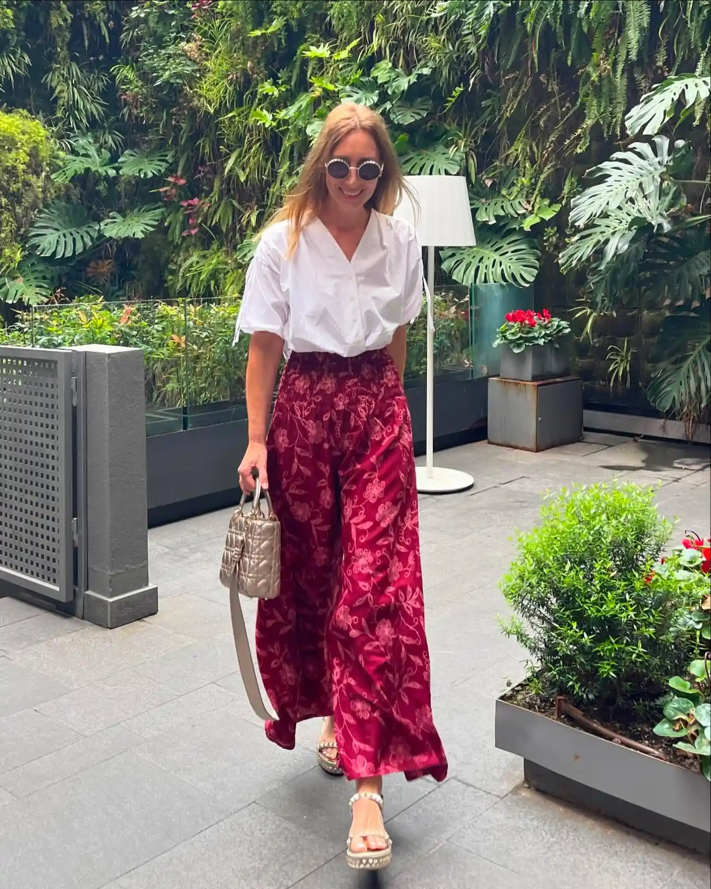 19 Holiday Outfits for Women Over 40 That Work for Parties, Dinners, and Sunny Trips 15 14. Burgundy Floral Wide Leg Pants With a White Blouse