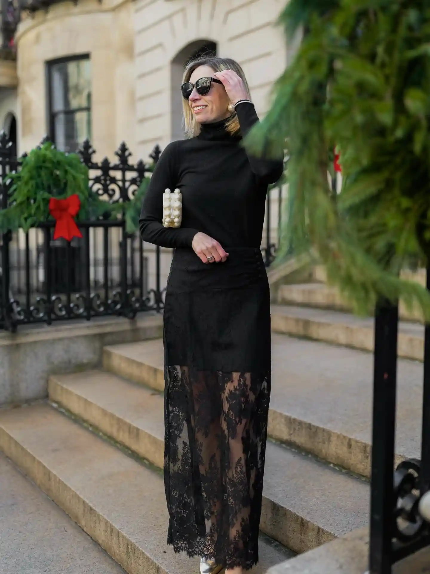 19 Holiday Outfits for Women Over 40 That Work for Parties, Dinners, and Sunny Trips 14 13. Black Turtleneck With a Lace Hem Maxi Skirt