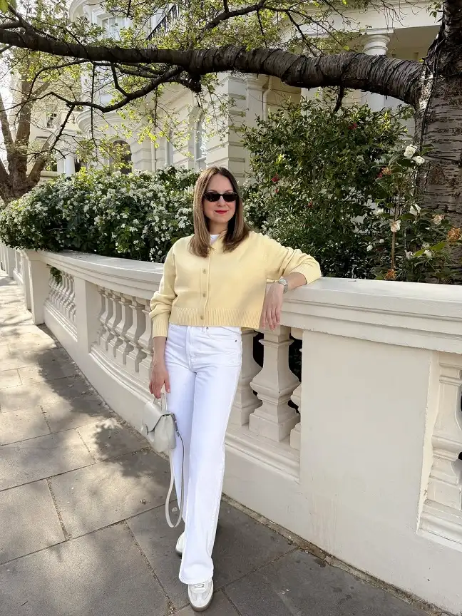 18 Spring Work Outfits for Women Over 40 That Feel Fresh, Not Fussy 14 Pale Yellow Cardigan With White Wide Leg Jeans