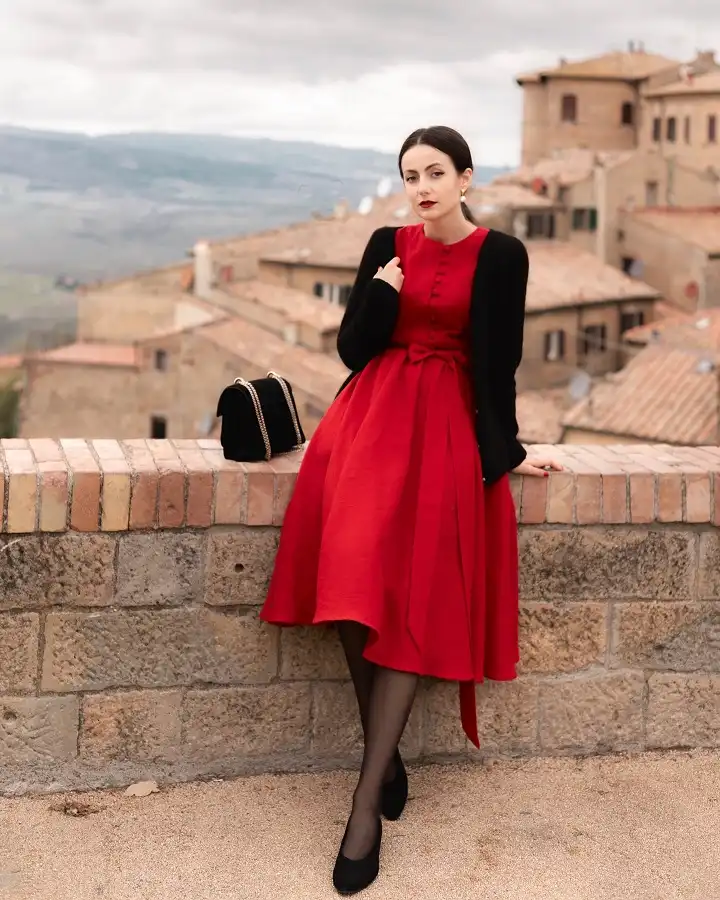 A Red Midi Dress With a Bow Belt and Black Cardigan
