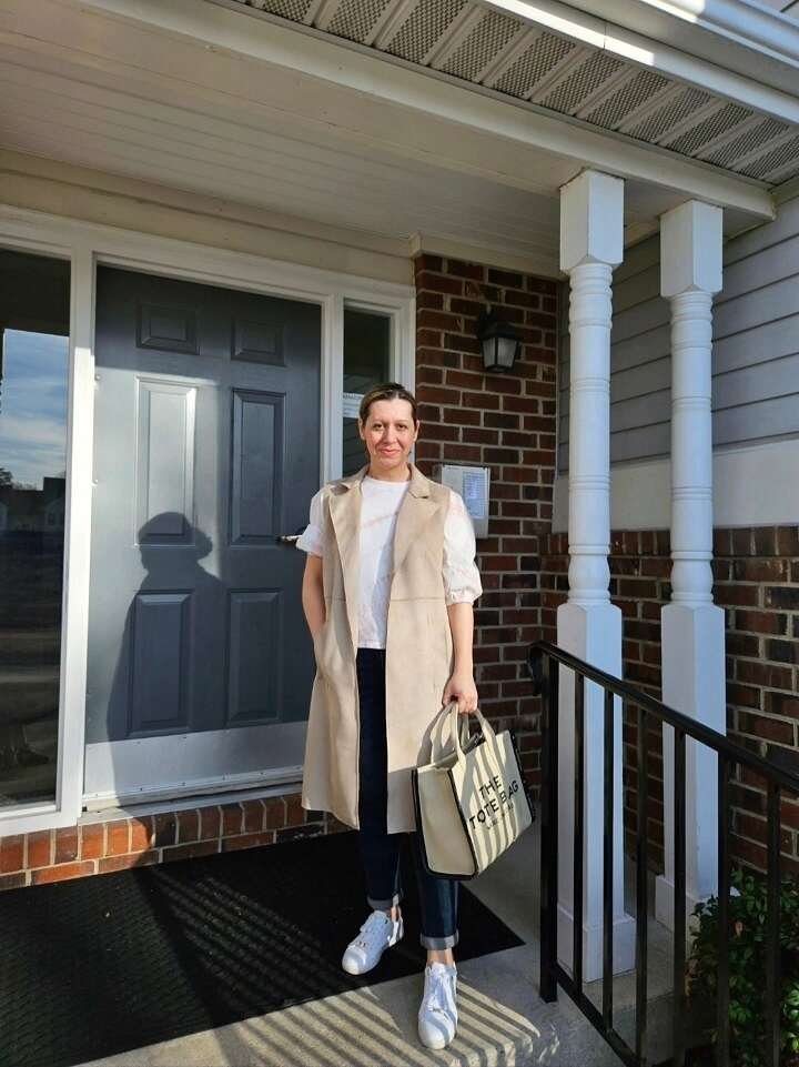 18 Spring Work Outfits for Women Over 40 That Feel Fresh, Not Fussy 3 Long Suede Vest Over Cuffed Jeans