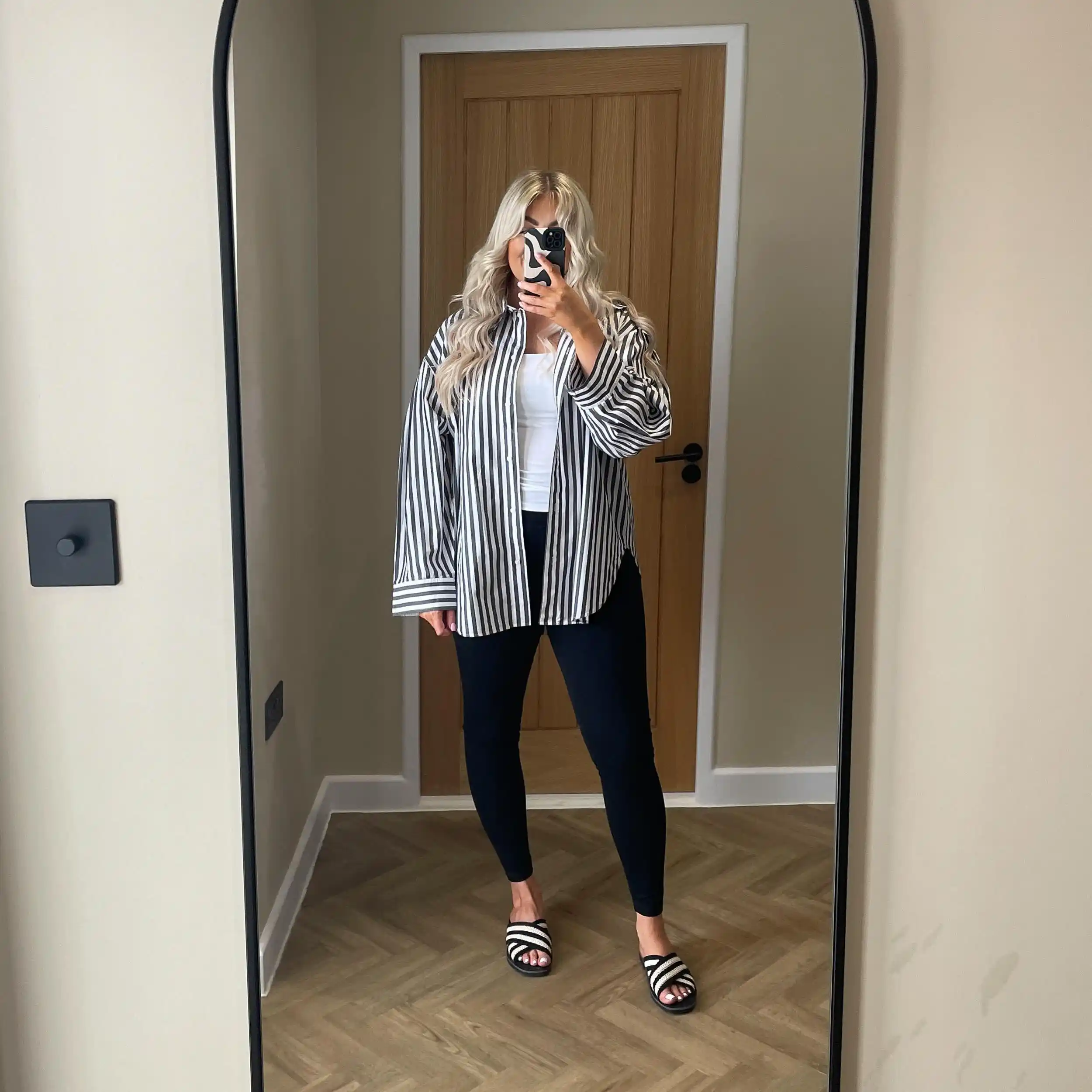 15 Leggings Outfits for Women Over 40 That Don't Look Sloppy 8 7. Striped Button Down with Black Leggings