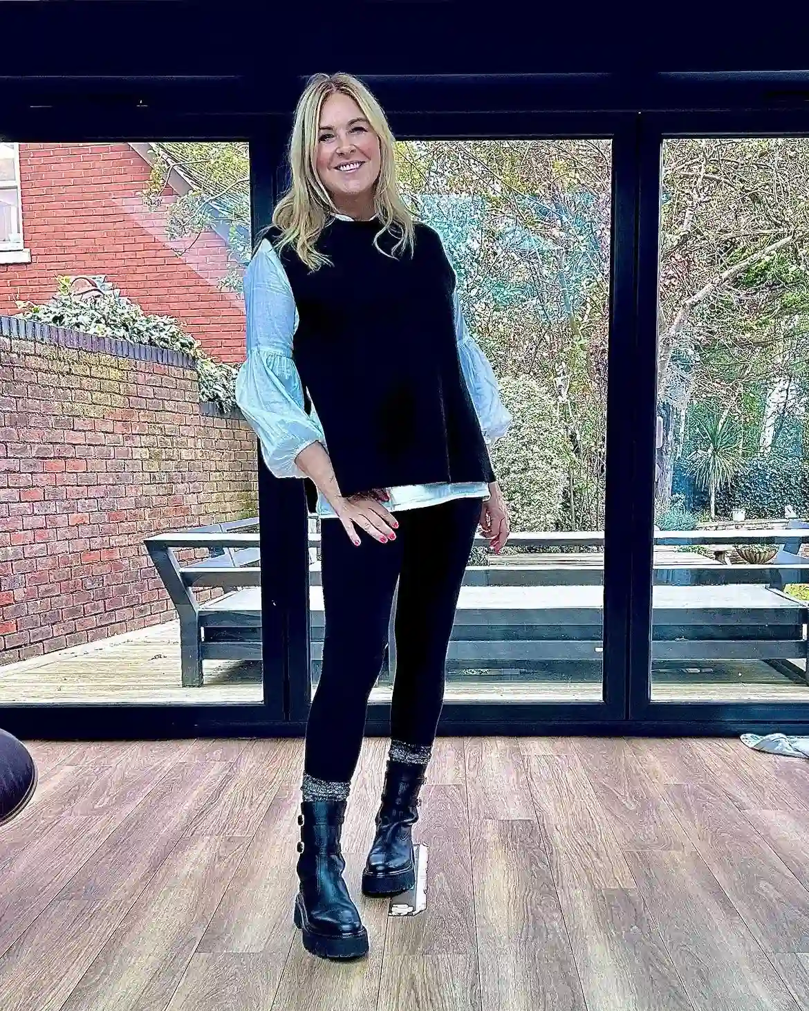 Modern Style: 20 Fall Outfits for Women Over 50 15 14. Sweater Vest with Puff Sleeve Shirt and Leggings