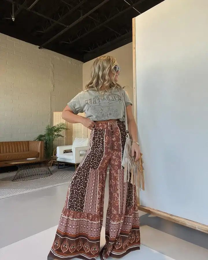 18 Boho Outfits for Women Over 40 (Not Costume-y) 5 Gray Graphic Tee with Paisley Palazzo Pants