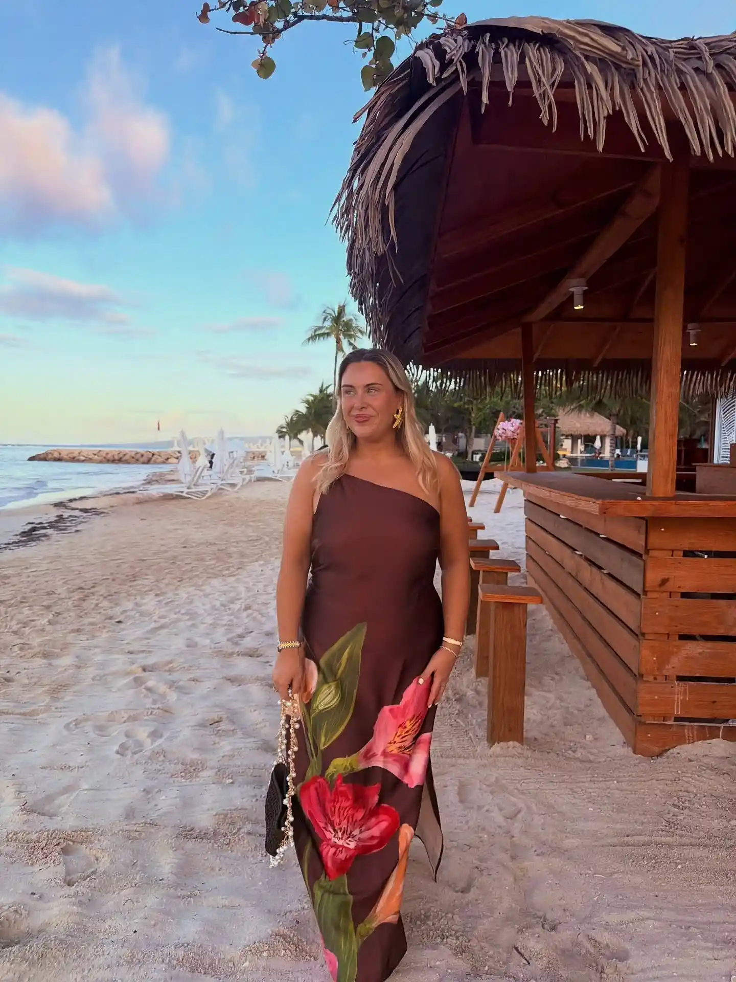 19 Holiday Outfits for Women Over 40 That Work for Parties, Dinners, and Sunny Trips 13 12. One Shoulder Floral Maxi for a Tropical Holiday