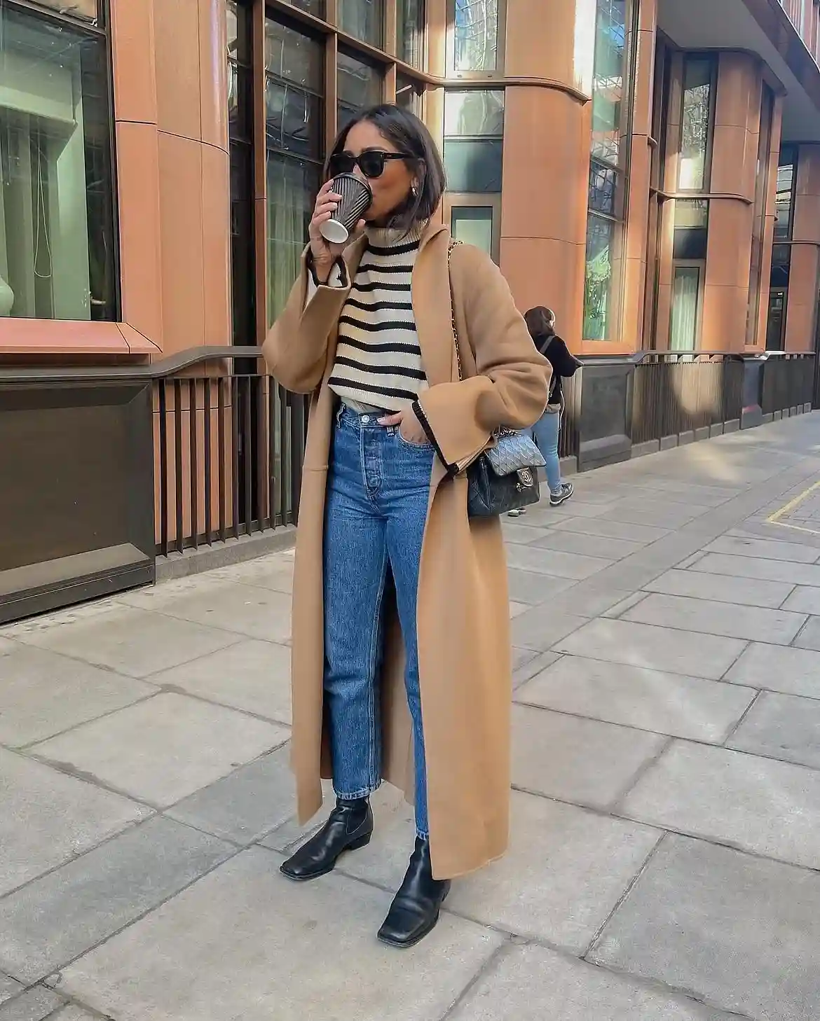 19 Winter Vacation Outfits Over 40 (Warm Getaways) 18 17. Camel Long Coat With a Striped Sweater and Jeans
