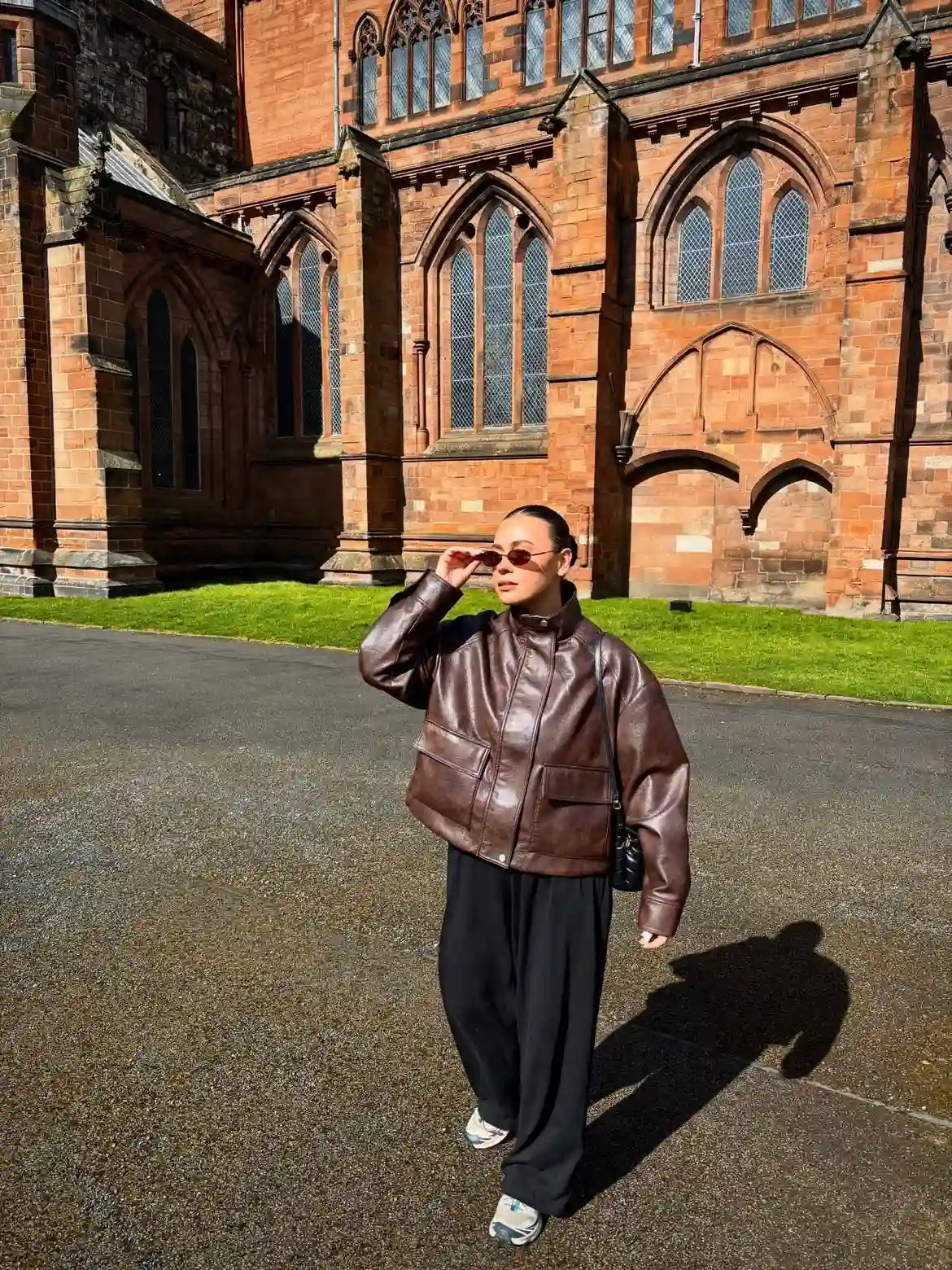 15 Leather Jacket Outfits for Women Over 40 That Actually Work 8 7. Cropped Chocolate Jacket with Black Trousers