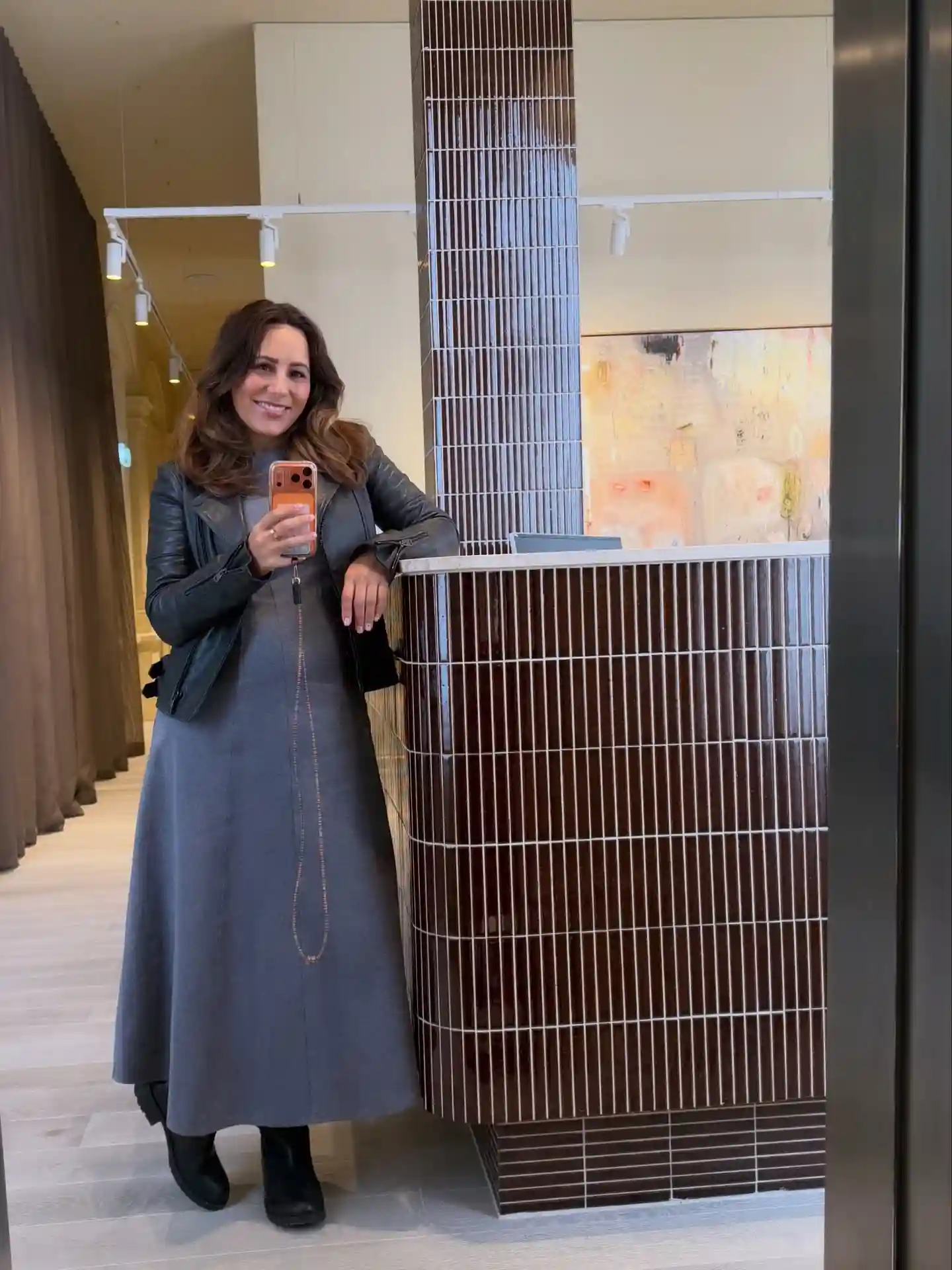 15 Leather Jacket Outfits for Women Over 40 That Actually Work 16 15. Cropped Moto Jacket Layered Over a Maxi Dress