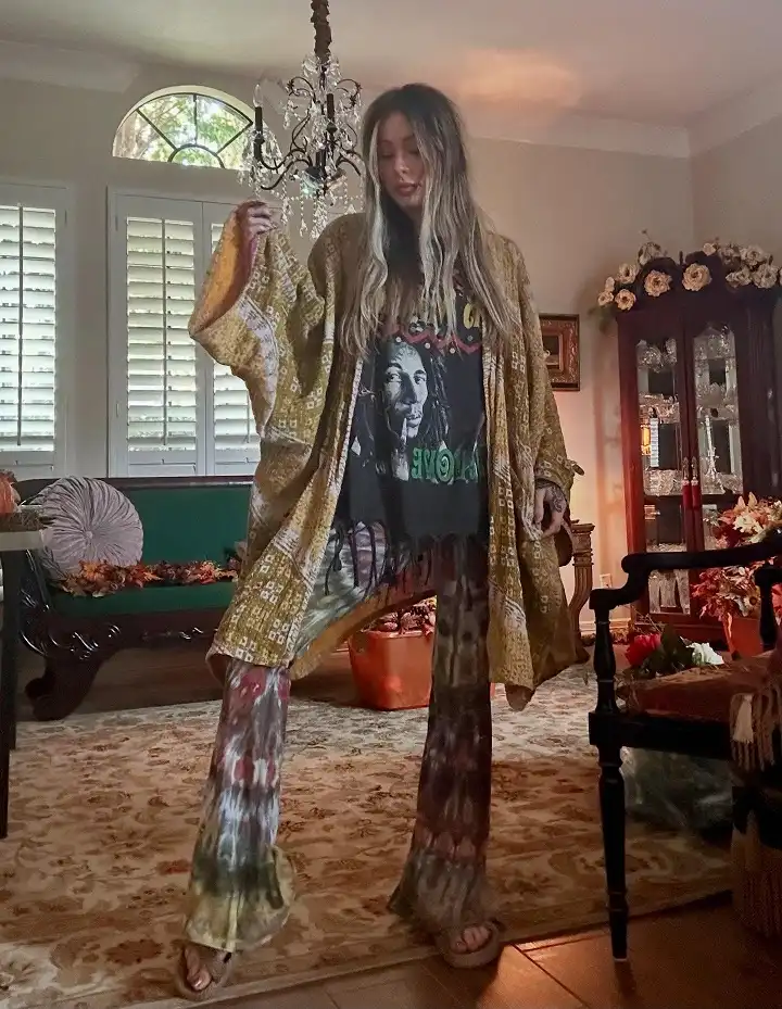 18 Boho Outfits for Women Over 40 (Not Costume-y) 15 Mustard Kimono with a Band Tee and Tie Dye Flares