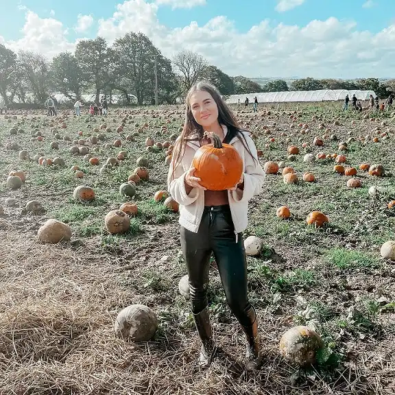 16 Pumpkin Patch Outfits Over 40 That Handle Mud, Hay, and Photos 8 Cream Jacket, Leather Look Leggings, and Rain Boots