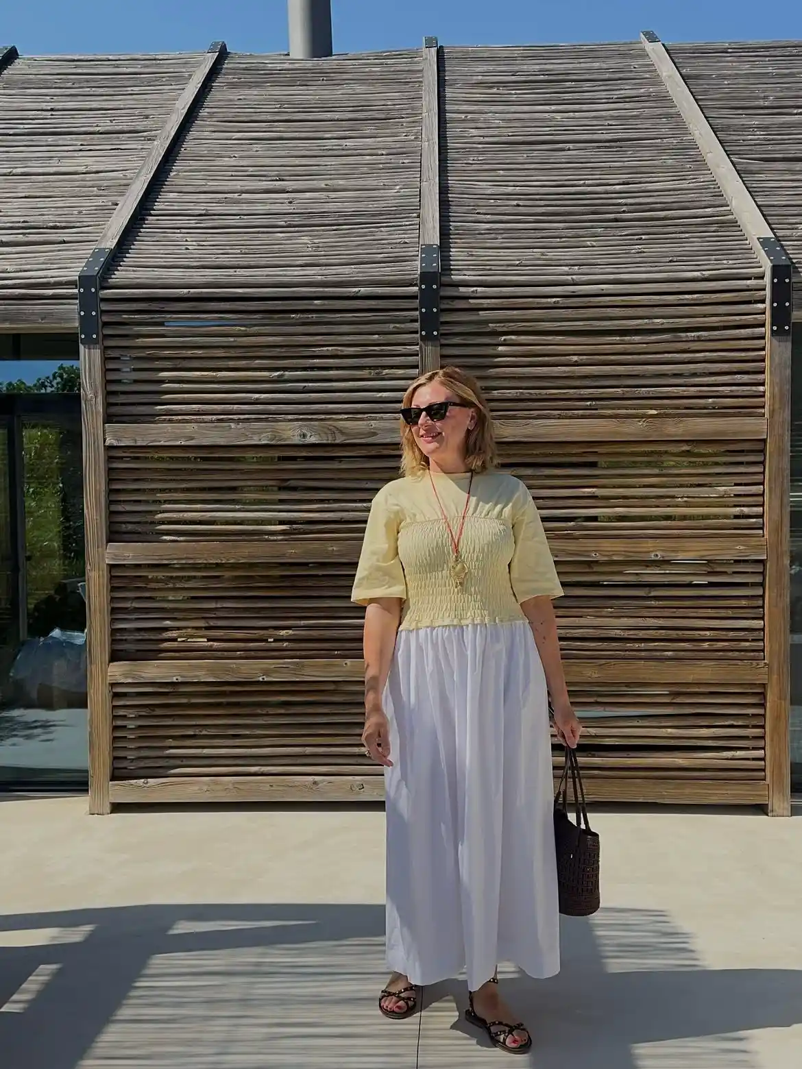 19 Holiday Outfits for Women Over 40 That Work for Parties, Dinners, and Sunny Trips 20 19. Butter Yellow Smocked Top With a White Maxi Skirt
