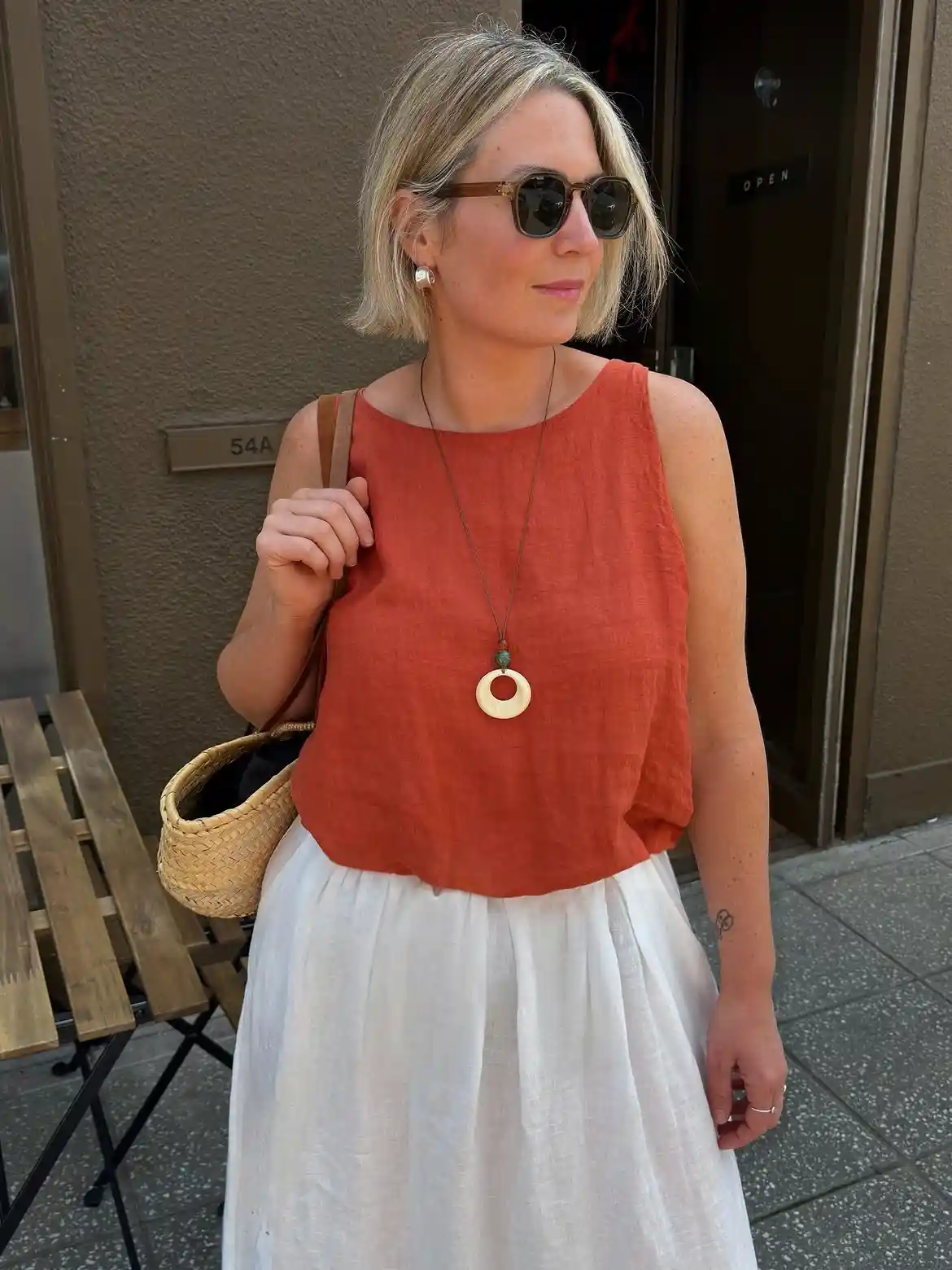15 Linen Outfits for Women Over 40 That Feel Easy and Look Polished 12 11. Rust Linen Tank With a White Skirt