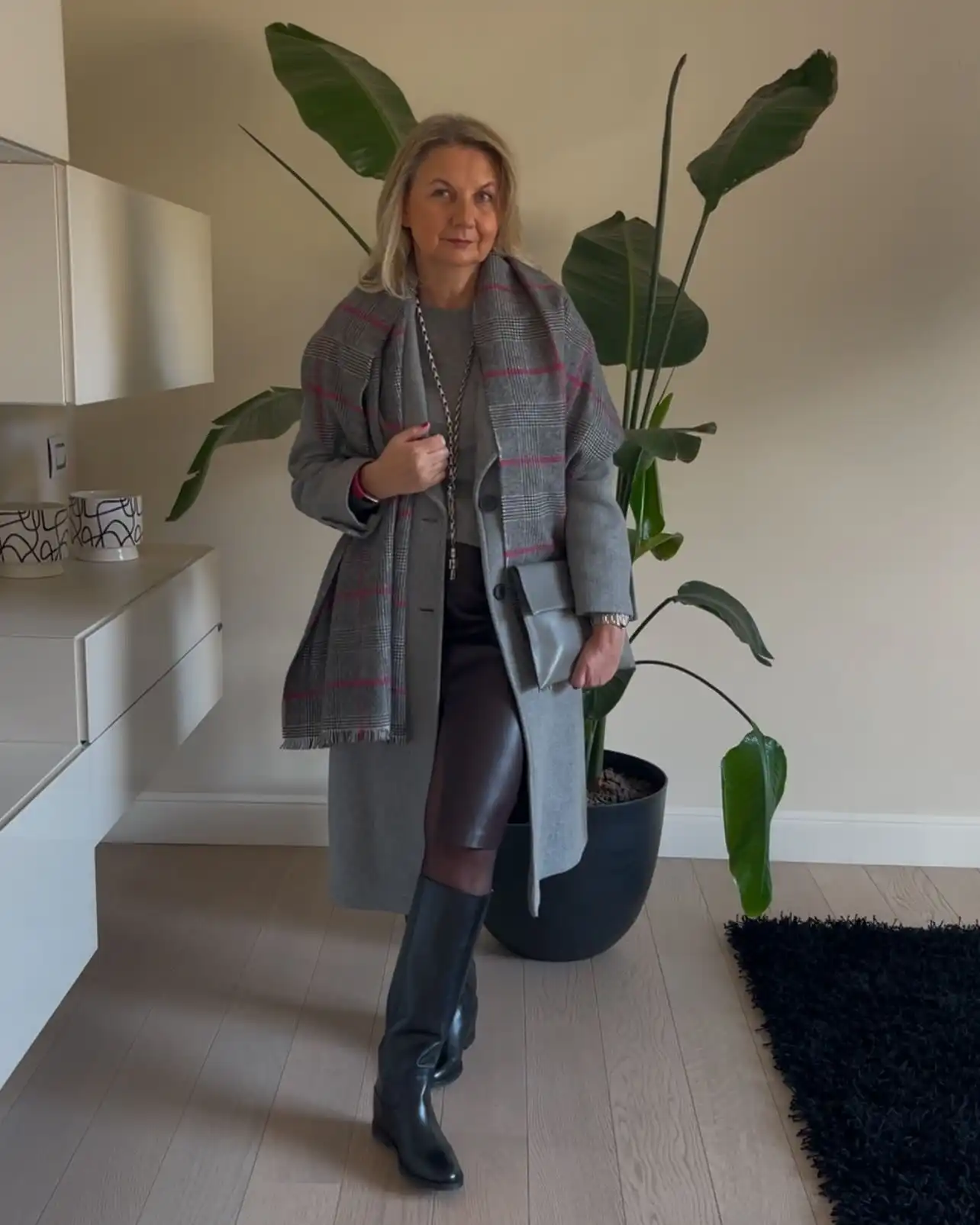 20 Classy Outfits for Women Over 40 17 Grey Coat, Plaid Scarf, and Leather Skirt