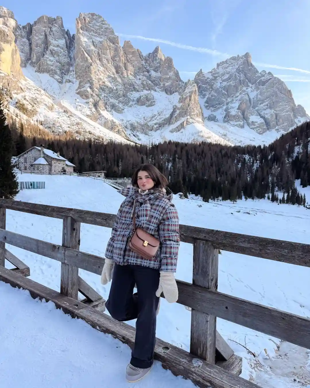 19 Winter Vacation Outfits Over 40 (Warm Getaways) 15 14. Plaid Puffer and Fuzzy Mittens in the Mountains
