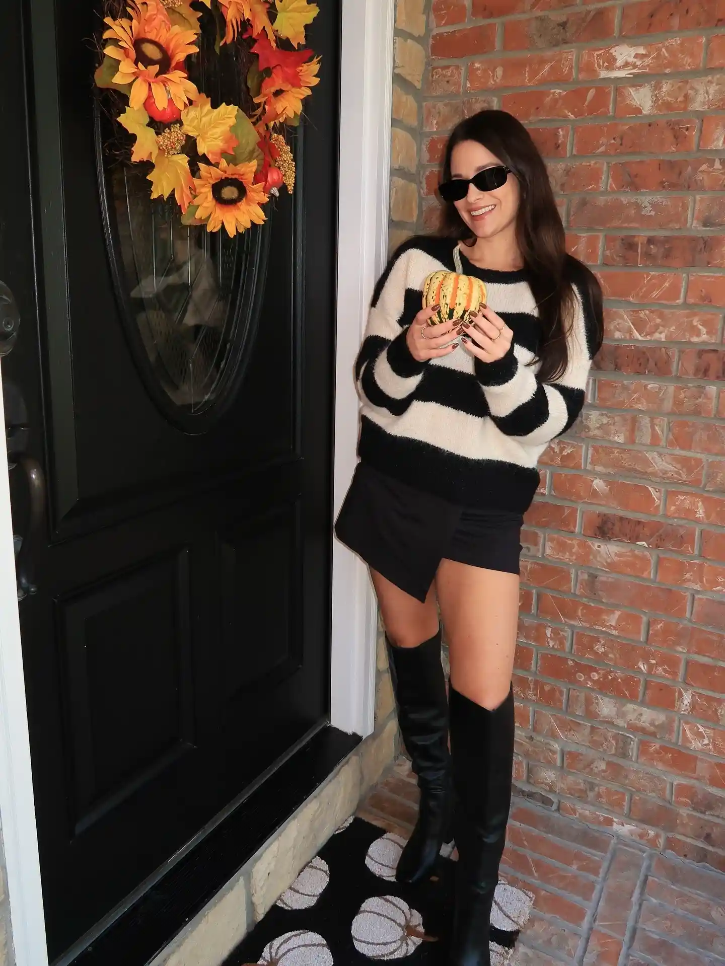 14 Knee-High Boot Outfits Over 40 14 13. A Striped Sweater Paired with Black Skort Boots