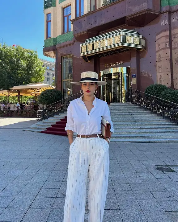 15 European Vacation Outfits for Women Over 40 3 White Shirt with Pinstripe Linen Trousers and a Boater Hat