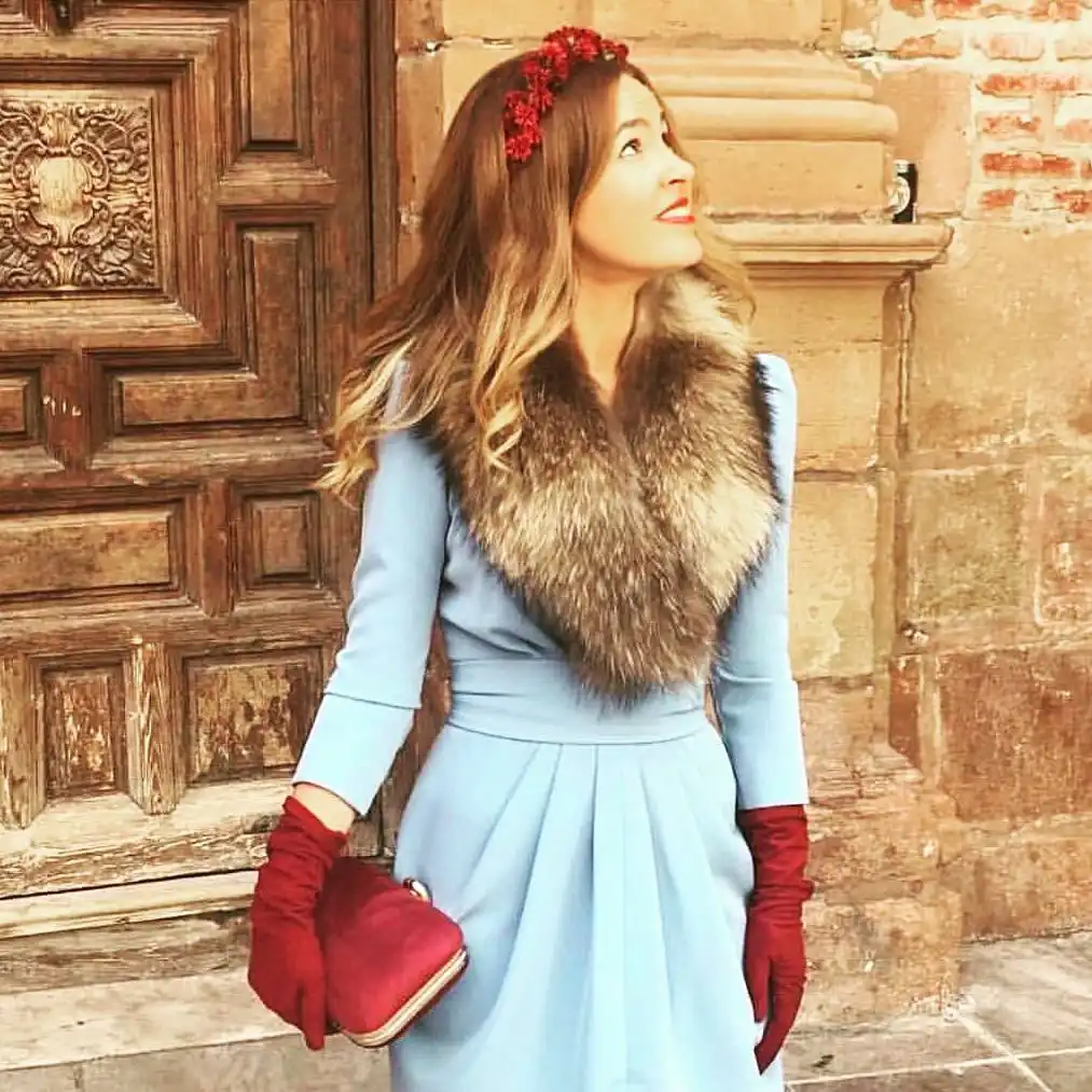 15 Winter Wedding Guest Outfits Over 40 That Handle the Cold 3 Pale Blue Dress With a Fur Stole and Red Gloves