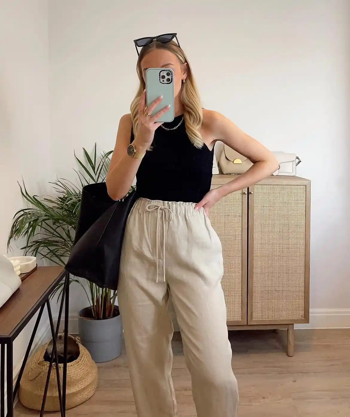 15 Linen Outfits for Women Over 40 That Feel Easy and Look Polished 10 9. Beige Drawstring Pants With a Black Halter Tank