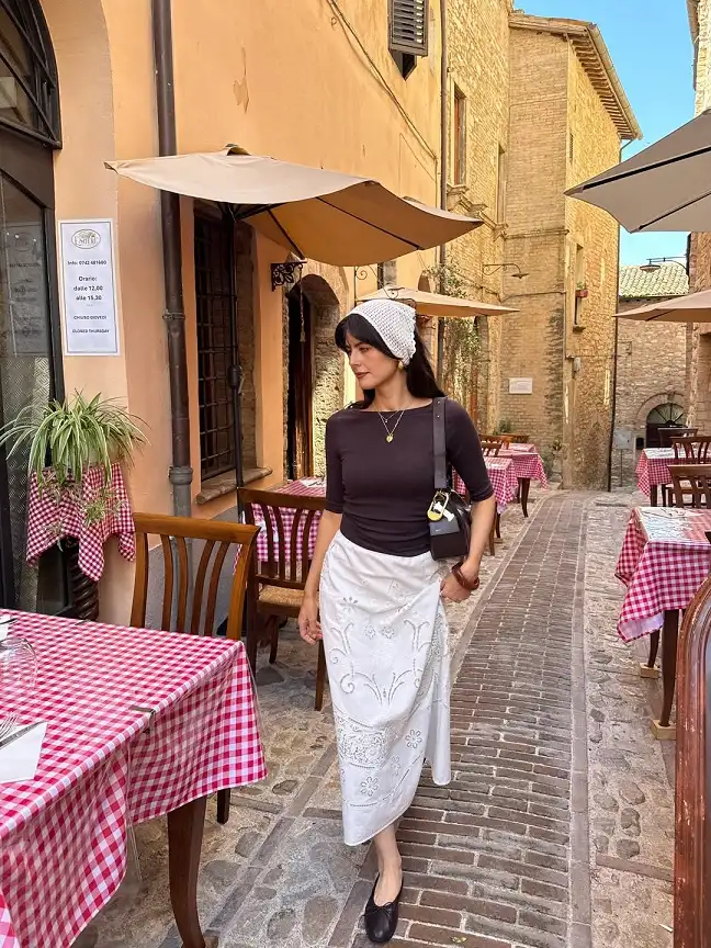 15 European Vacation Outfits for Women Over 40 6 Brown Boat Neck Top with a White Cutwork Skirt