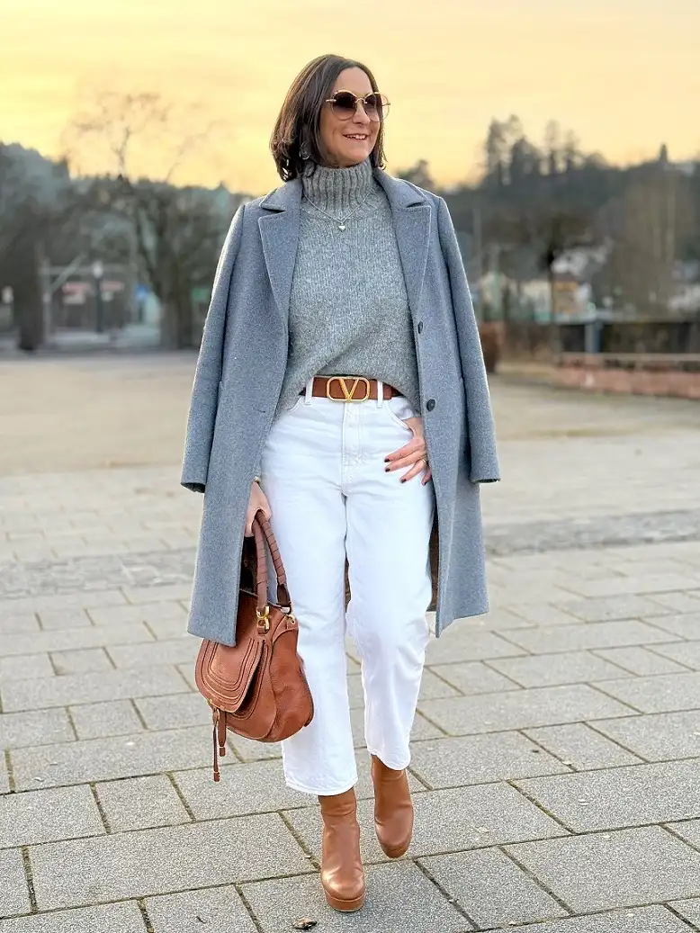 20 Chic Winter Outfits for Women Over 40 That Aren't Frumpy 18 Blue Grey Coat With White Jeans