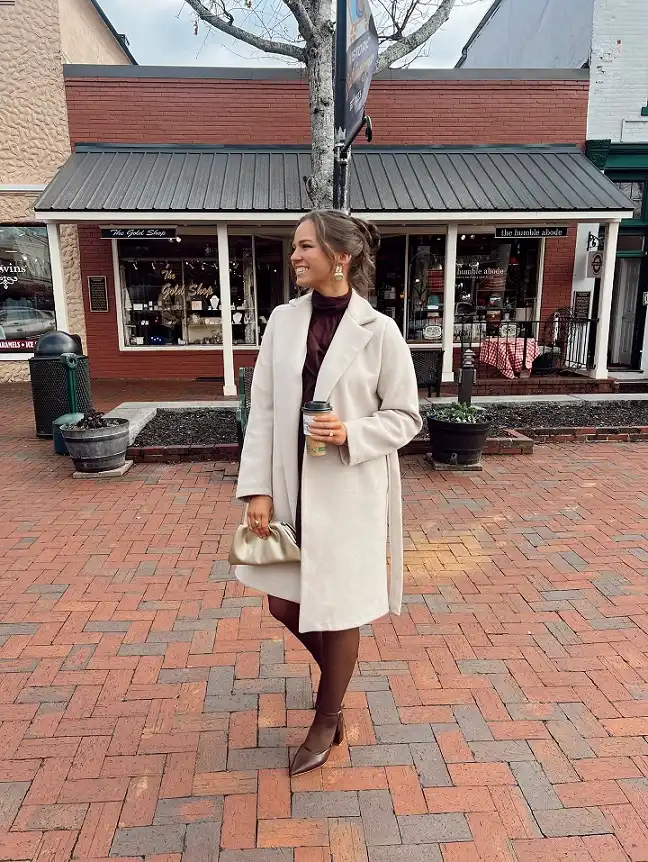 15 Winter Wedding Guest Outfits Over 40 That Handle the Cold 7 Ivory Wool Coat Over a Burgundy Turtleneck Dress