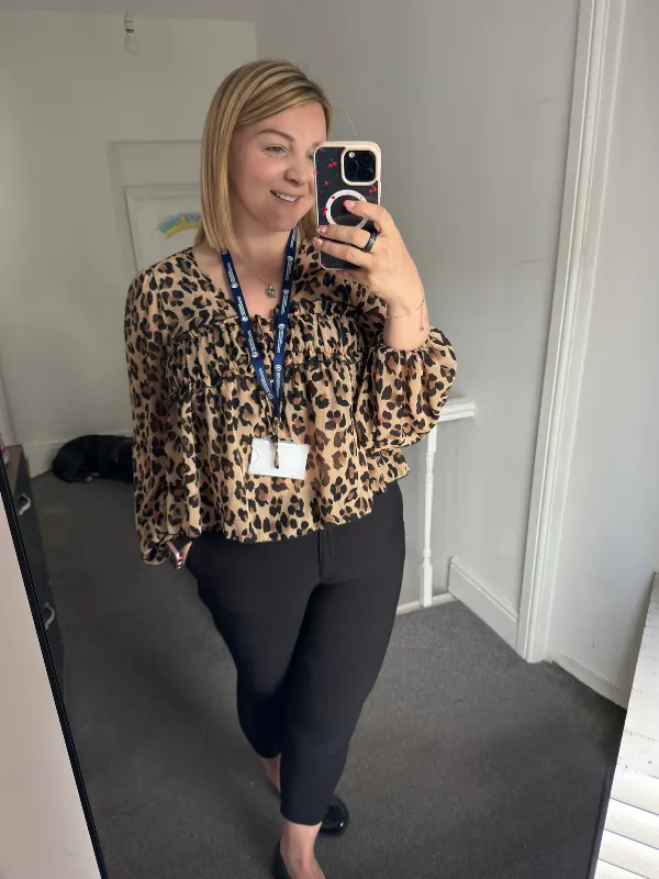 15 Business Casual Outfits for Women Over 40 2 1. Leopard Print Blouse with Black Trousers
