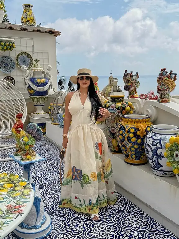17 Italy Vacation Outfits for Women Over 40 That Look Effortlessly Chic 7 Ivory Halter Maxi with a Painted Floral Hem