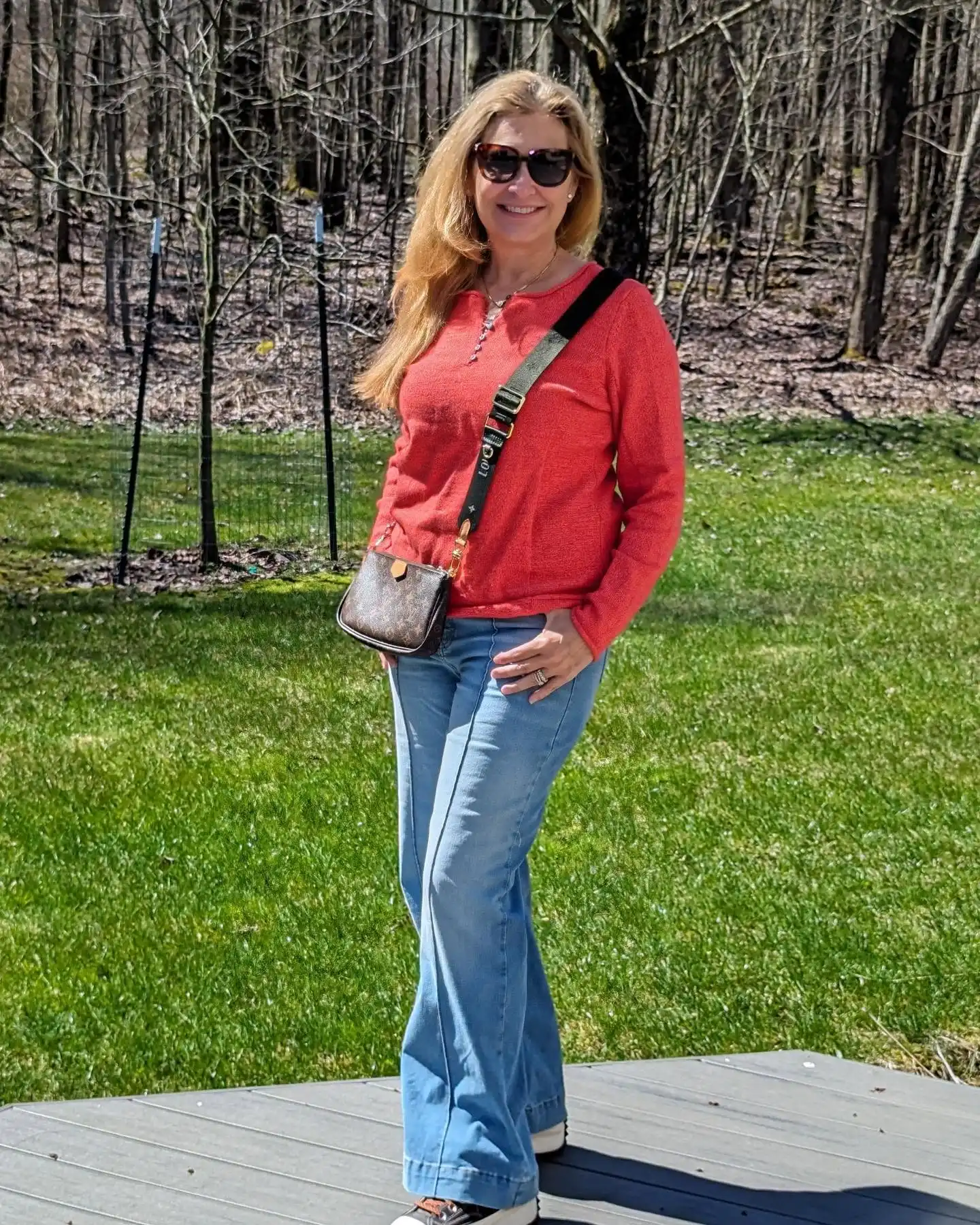 20 Classy Outfits for Women Over 40 20 Coral Sweater with Light Wash Wide Leg Jeans