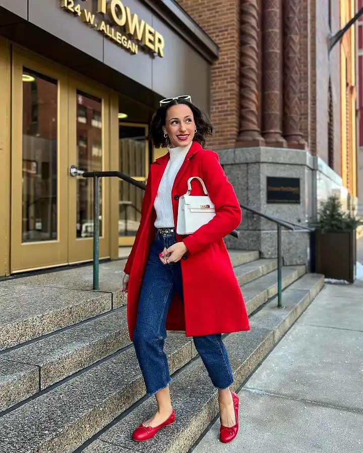 Red Coat Over a Cream Sweater and Dark Jeans