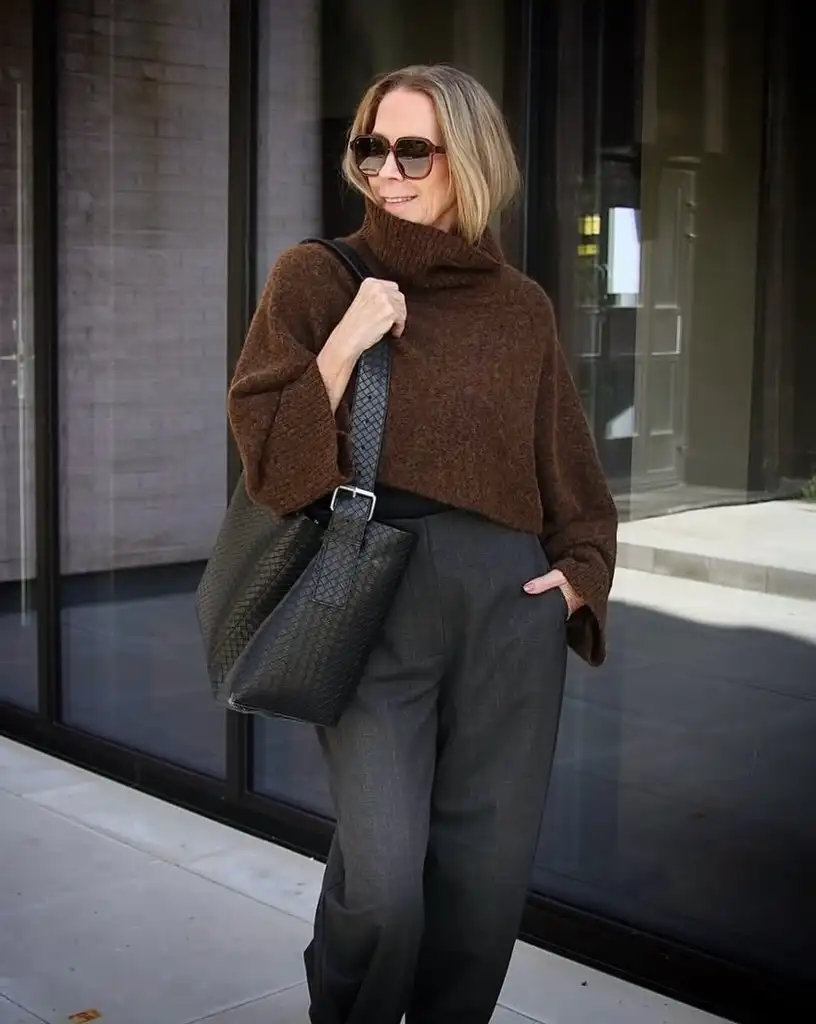 20 Chic Winter Outfits for Women Over 40 That Aren't Frumpy 21 Brown Poncho Sweater With Grey Trousers