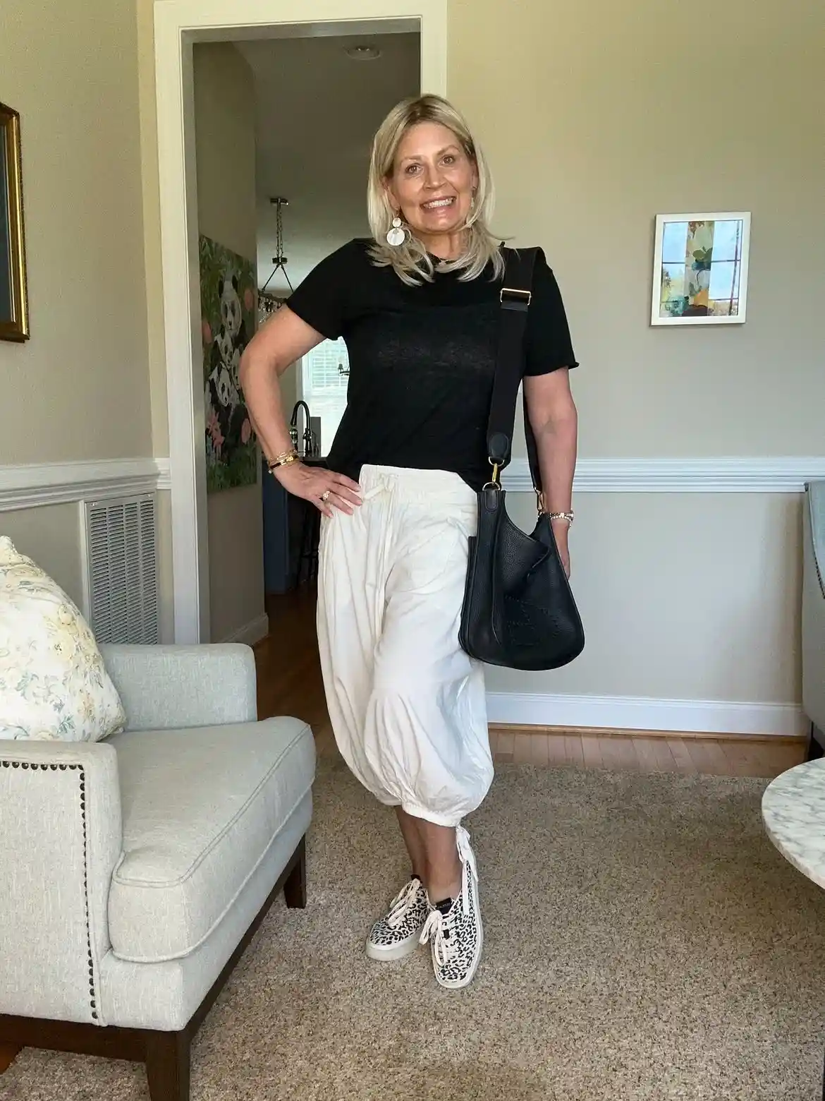 Modern Style: 20 Fall Outfits for Women Over 50 3 2. Black Tee with White Balloon Pants