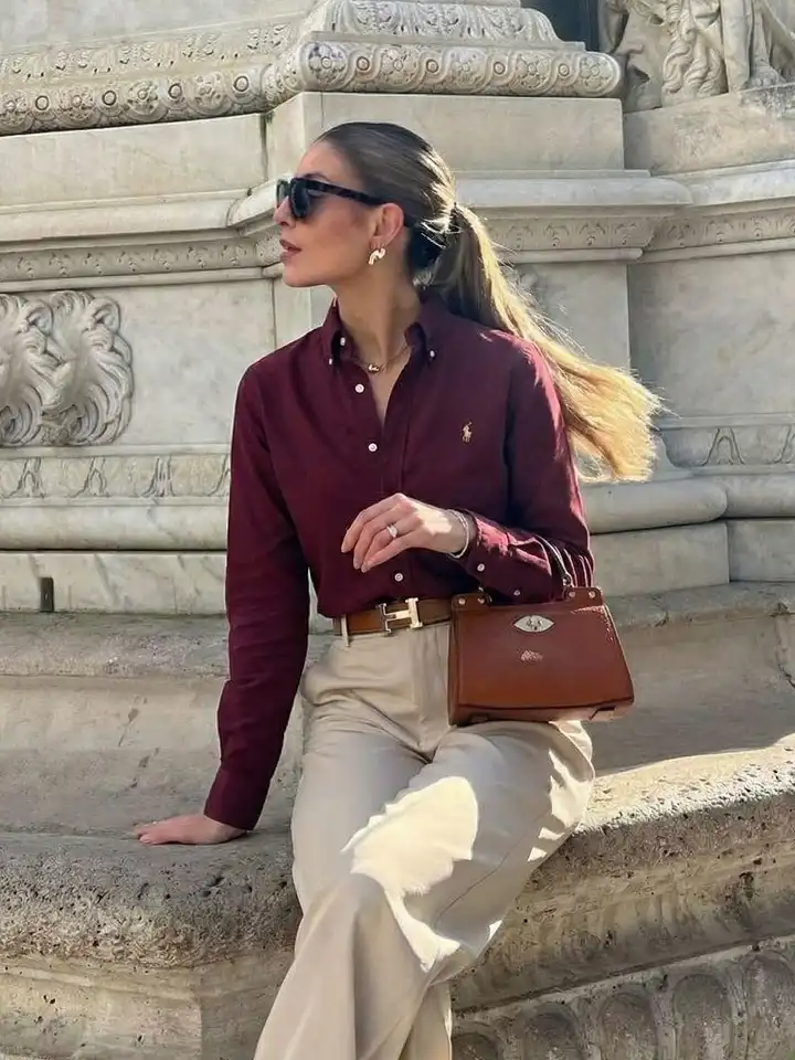 17 Old Money Outfits for Women Over 40 That Look Rich Without Trying 9 A Burgundy Oxford Shirt With Beige Trousers and Cognac Leather