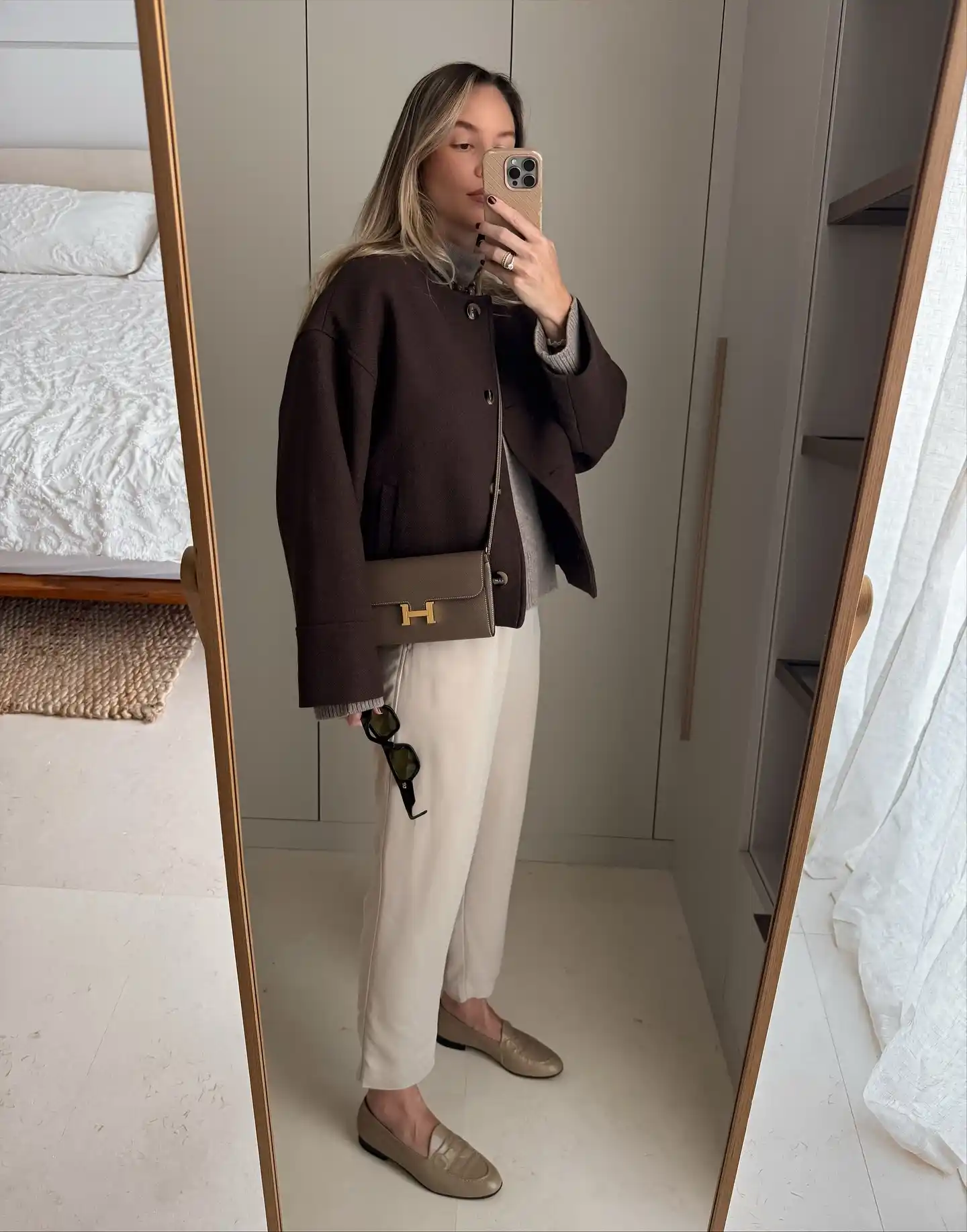 15 Fall Transitional Outfits for Women Over 40 (Summer-to-Fall) 12 11. Chocolate Wool Jacket Over Grey Knit and Cream Trousers