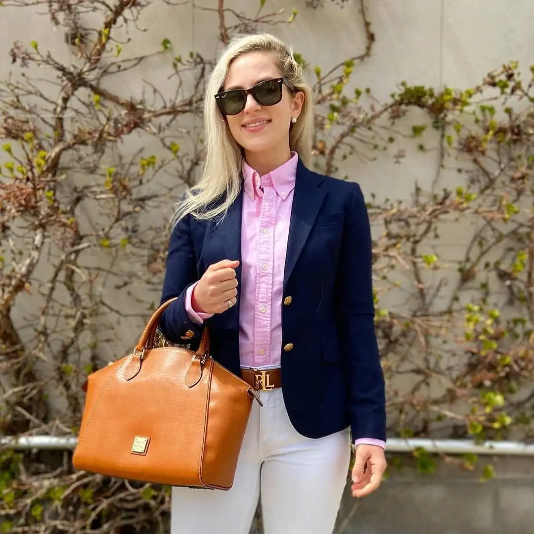 18 Preppy Outfits for Women Over 40 13 Navy Blazer, Pink Oxford Shirt, and White Jeans