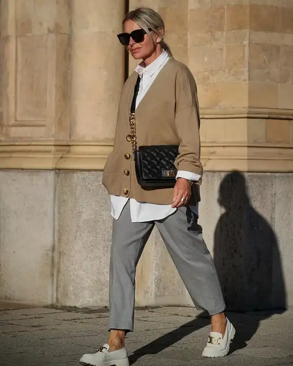 17 Old Money Outfits for Women Over 40 That Look Rich Without Trying 11 A Camel Cardigan Layered Over a Long White Shirt