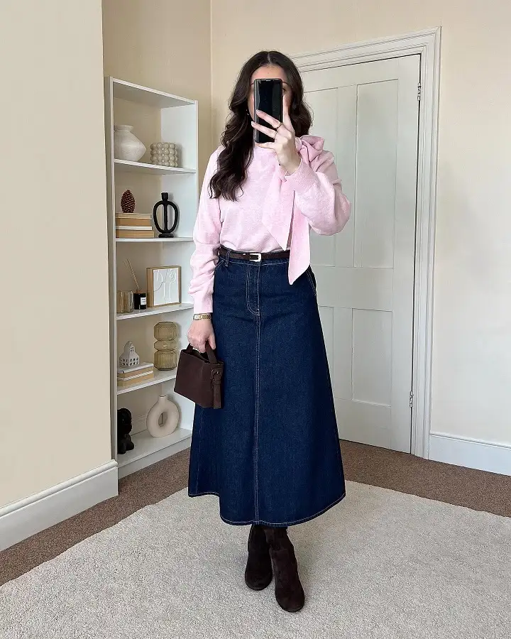 18 Spring Work Outfits for Women Over 40 That Feel Fresh, Not Fussy 11 Pink Bow Sweater and Dark Denim Midi Skirt