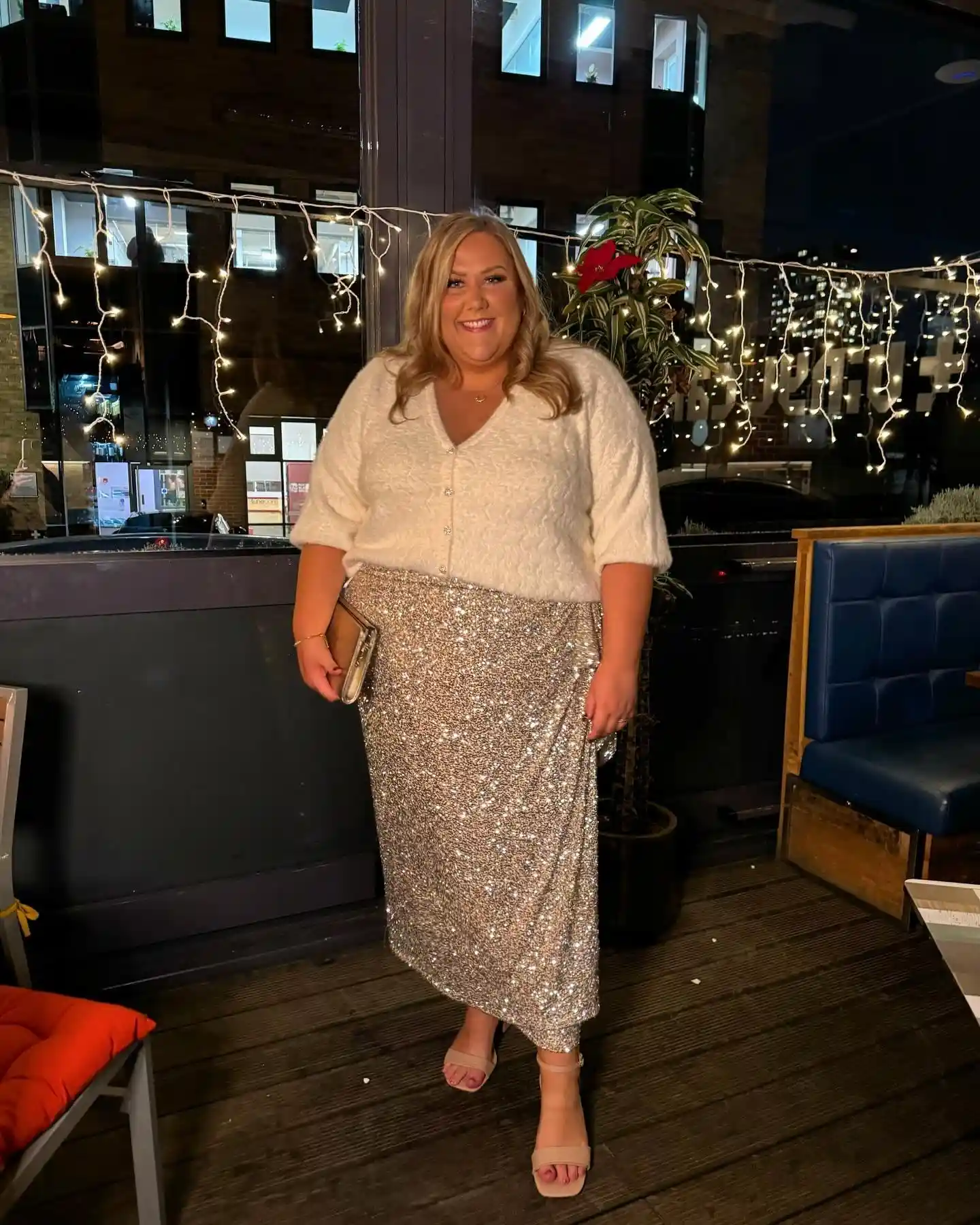 19 Holiday Outfits for Women Over 40 That Work for Parties, Dinners, and Sunny Trips 8 7. Sequin Midi Skirt With a Fluffy Cream Cardigan