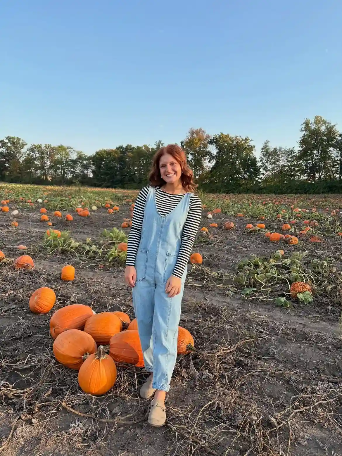 16 Pumpkin Patch Outfits Over 40 That Handle Mud, Hay, and Photos 9 1. Denim Overalls With A Striped Top