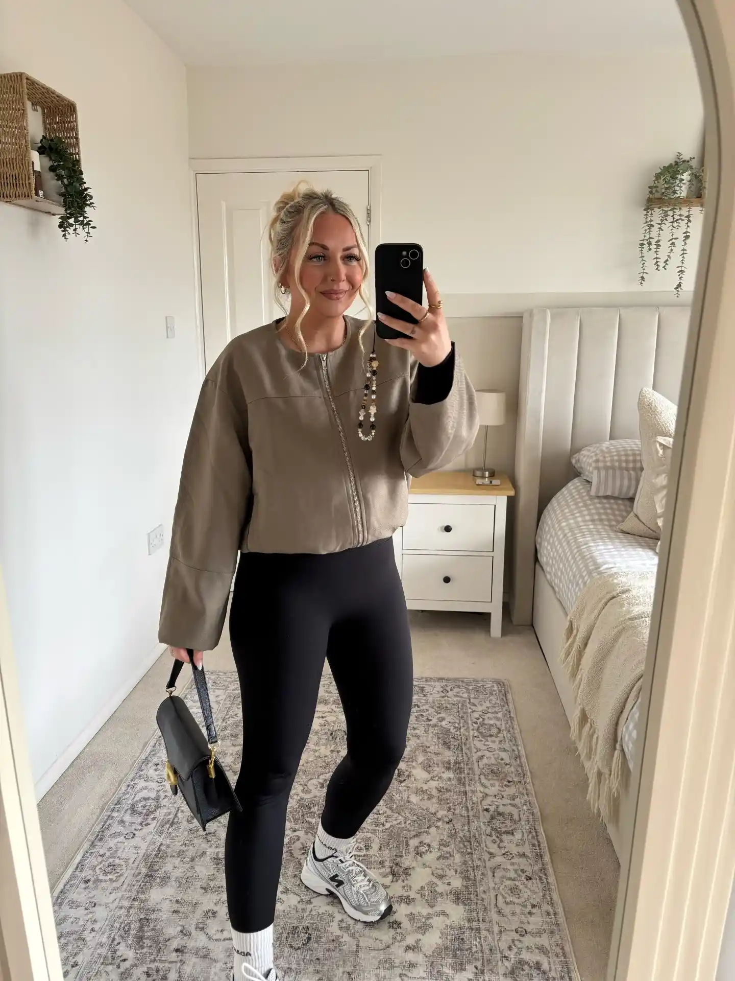 15 Leggings Outfits for Women Over 40 That Don't Look Sloppy 3 2. Cropped Bomber Jacket with Black Leggings