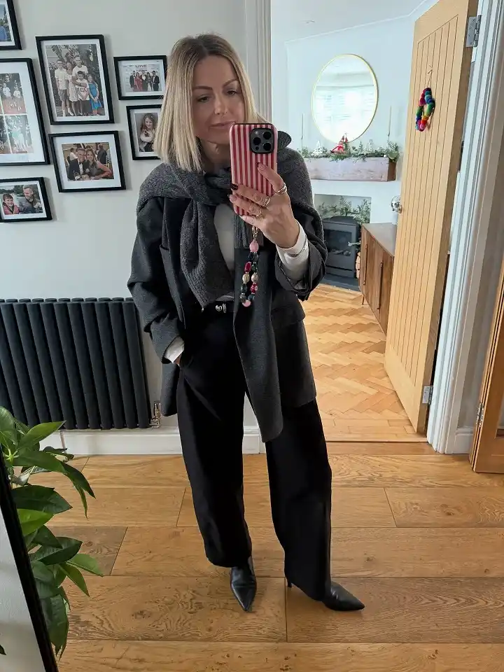 18 Winter Work Outfits for Women Over 40 10 A Grey Coat Layered Over A Tucked In Scarf