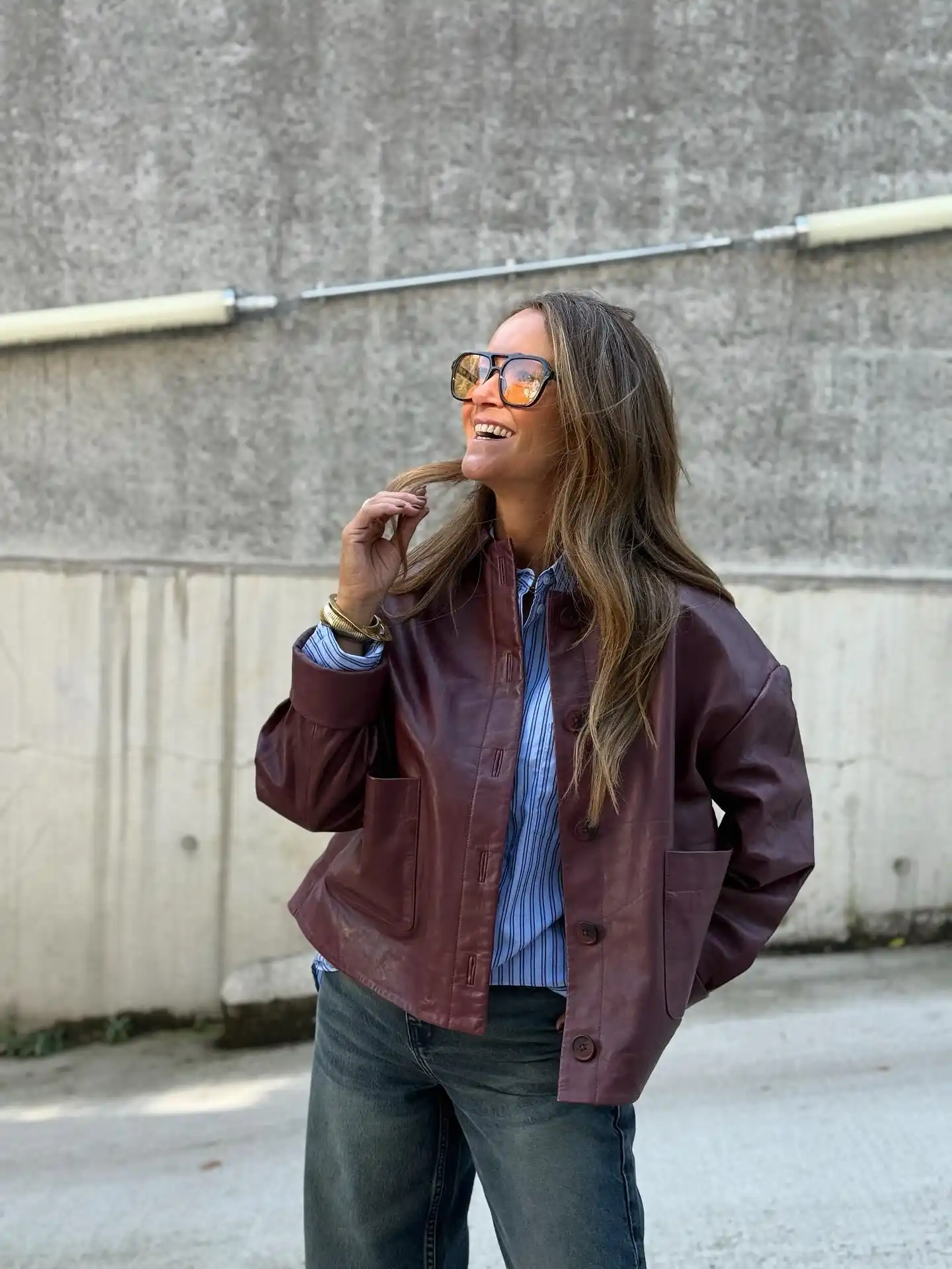 15 Leather Jacket Outfits for Women Over 40 That Actually Work 13 12. Burgundy Leather Chore Jacket with Striped Shirt