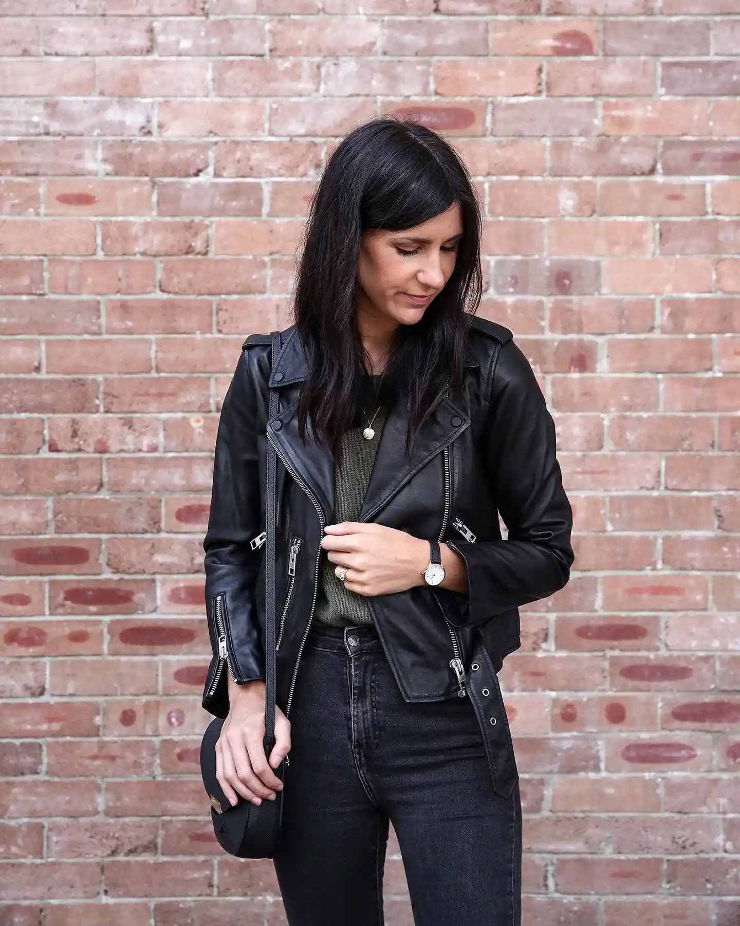 15 Leather Jacket Outfits for Women Over 40 That Actually Work 11 10. Classic Black Moto Jacket with Olive Sweater