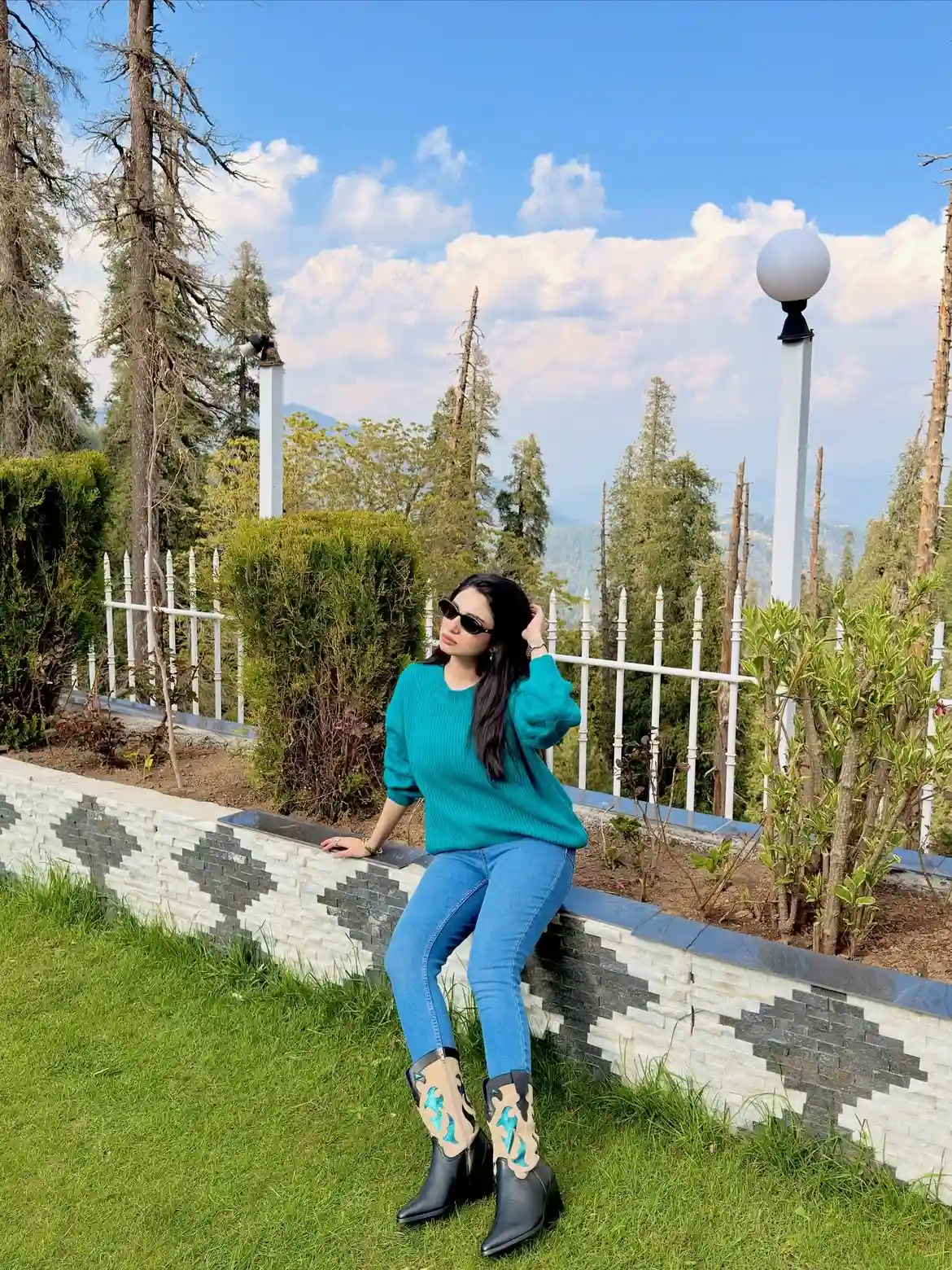 19 Winter Vacation Outfits Over 40 (Warm Getaways) 9 8. Teal Sweater and Cowboy Boots for a Sunny Trip